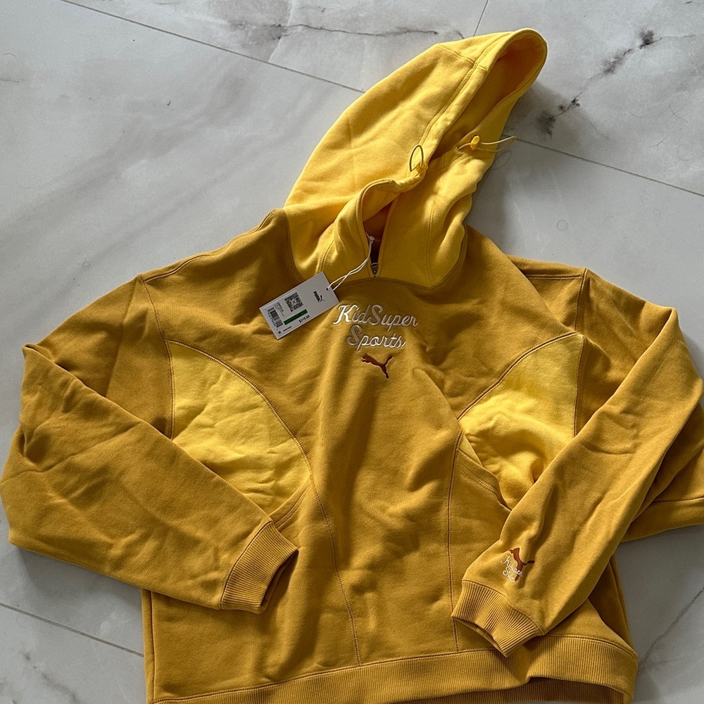 Puma Kidsuper Sports Pullover Hoodie in Mustard Yellow with Maroon Logo